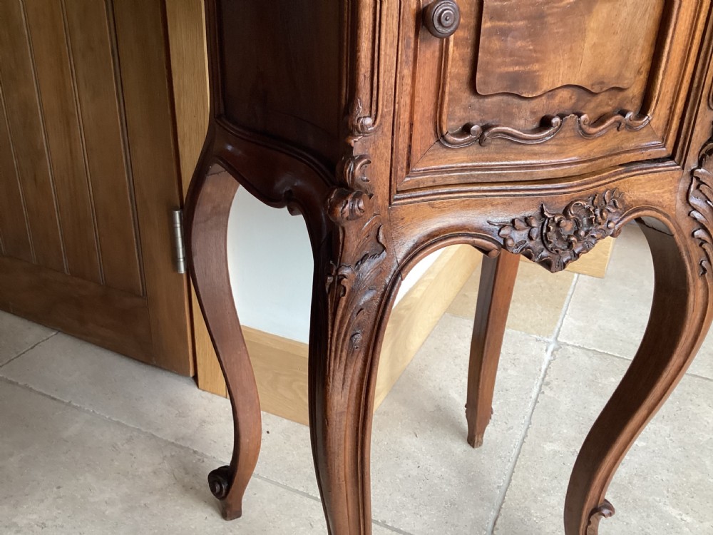 An antique French Rococo style carved walnut pot cupboard with a contoured red marble top and slender cabriole legs. View III