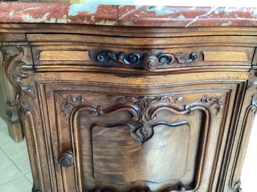 An antique French Rococo style carved walnut pot cupboard with a contoured red marble top and slender cabriole legs. View IV