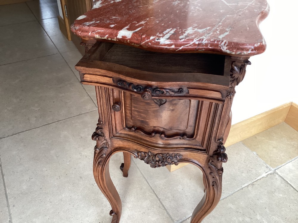 An antique French Rococo style carved walnut pot cupboard with a contoured red marble top and slender cabriole legs. View V