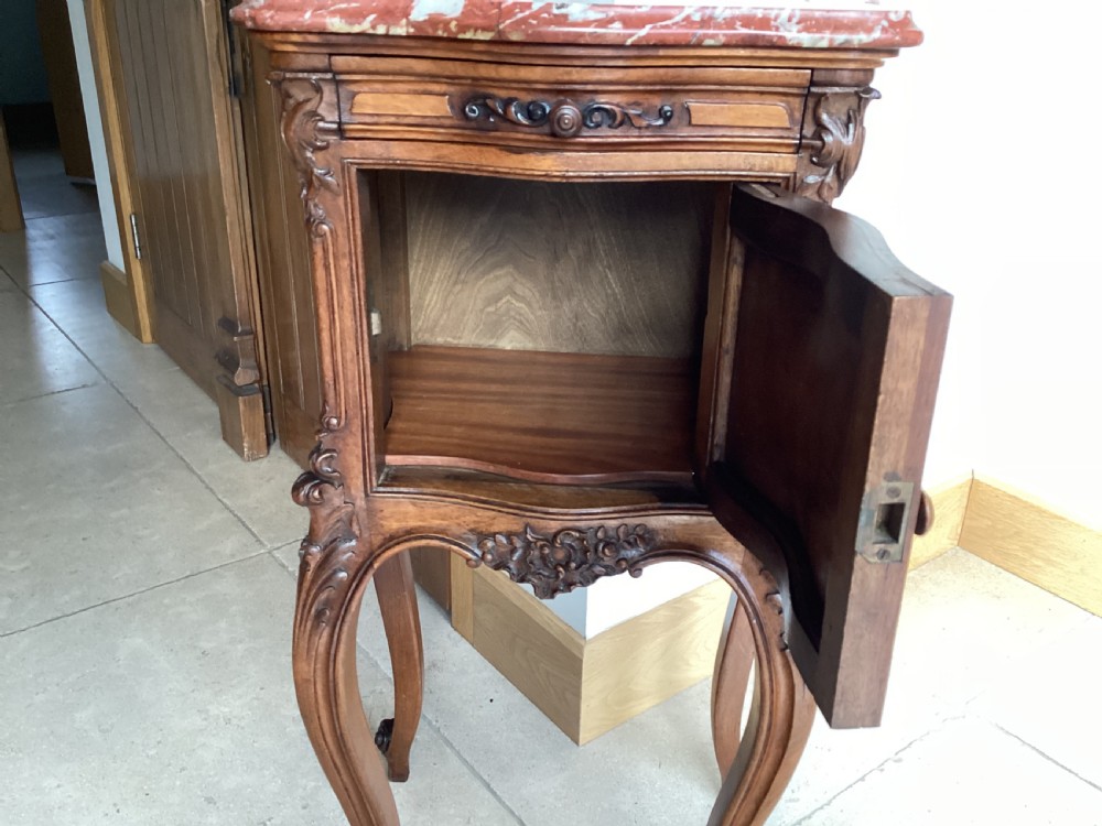 An antique French Rococo style carved walnut pot cupboard with a contoured red marble top and slender cabriole legs. View VI