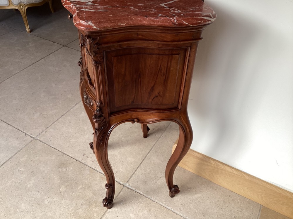 An antique French Rococo style carved walnut pot cupboard with a contoured red marble top and slender cabriole legs. View VII