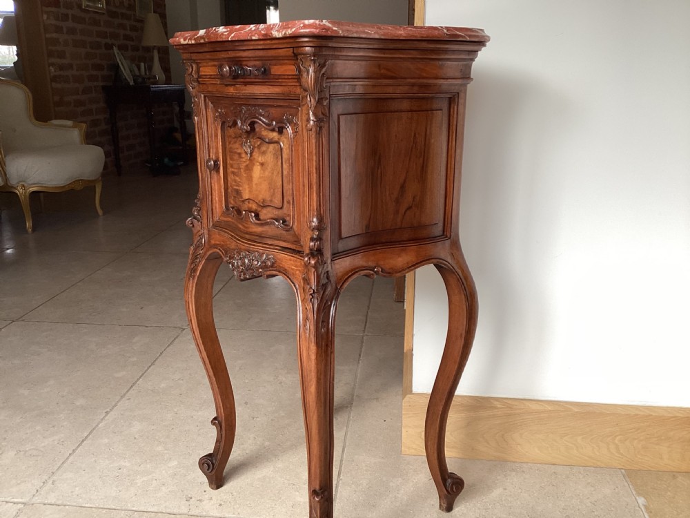 An antique French Rococo style carved walnut pot cupboard with a contoured red marble top and slender cabriole legs. View X