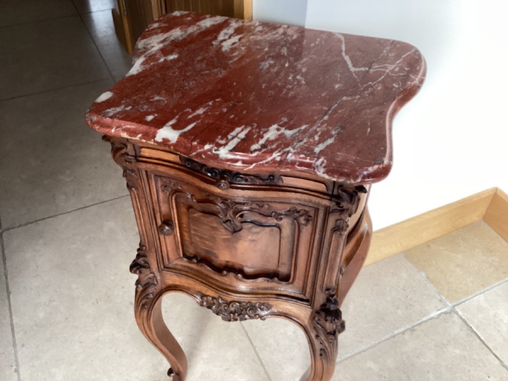 An antique French Rococo style carved walnut pot cupboard with a contoured red marble top and slender cabriole legs. View XII
