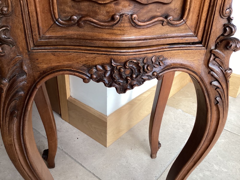 An antique French Rococo style carved walnut pot cupboard with a contoured red marble top and slender cabriole legs. View XIII