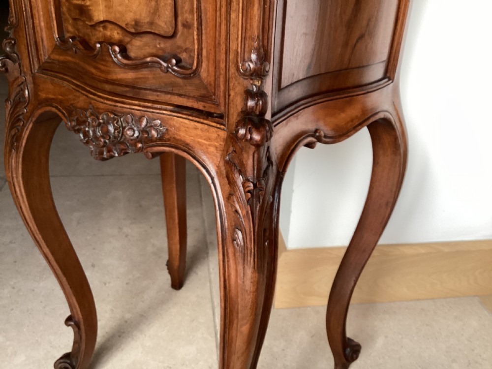 An antique French Rococo style carved walnut pot cupboard with a contoured red marble top and slender cabriole legs. View XV