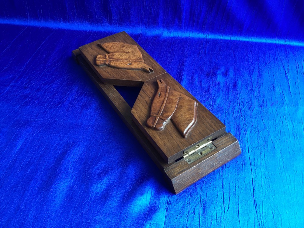 A solid oak Art Deco desktop book trough featuring angled side supports with carved horse silhouettes connected by twin horizontal rails. View II