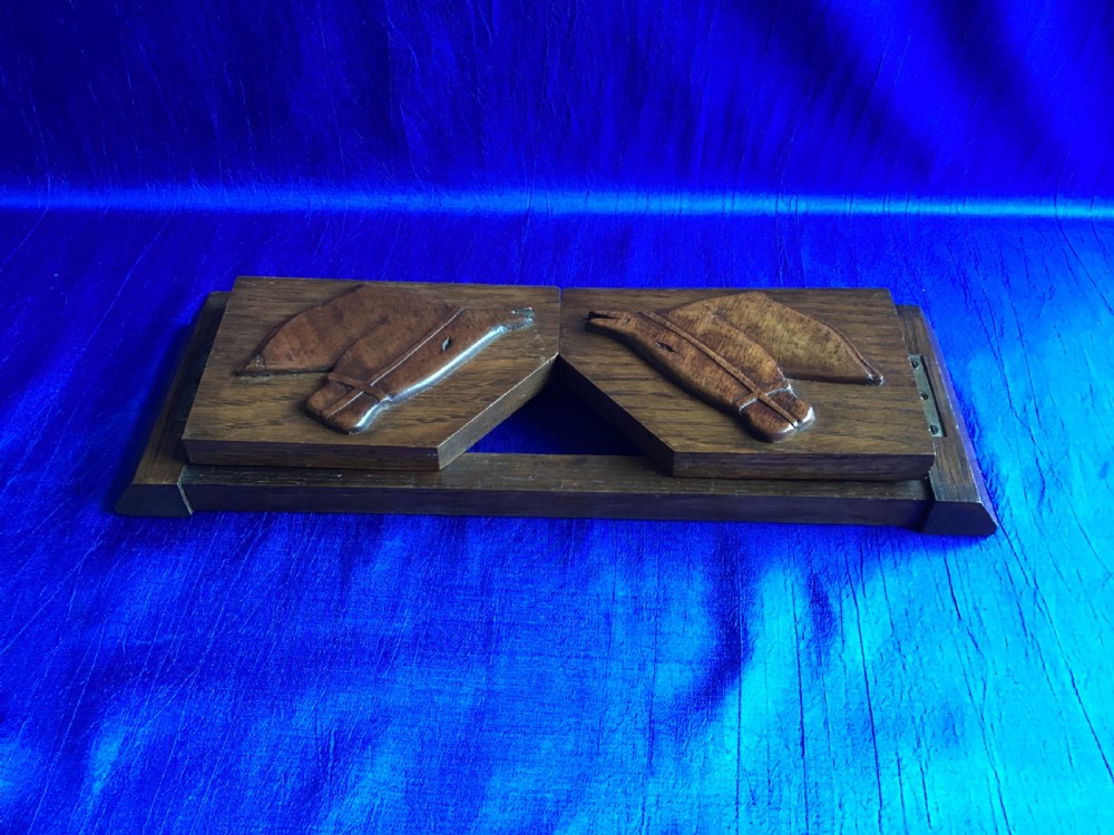 A solid oak Art Deco desktop book trough featuring angled side supports with carved horse silhouettes connected by twin horizontal rails. View VII