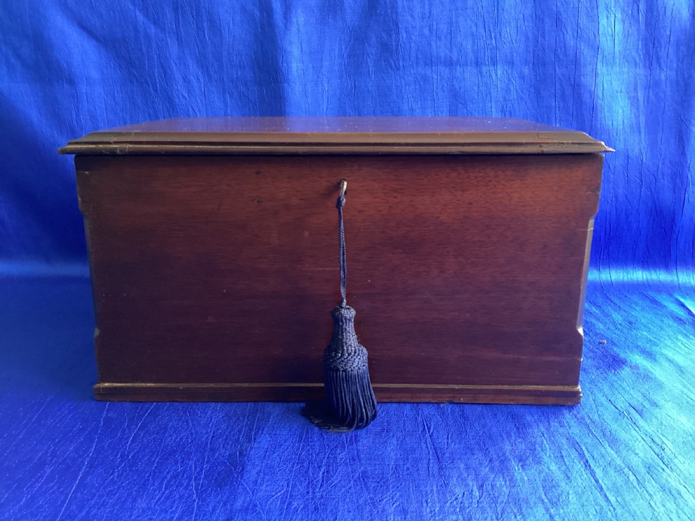 A rectangular dark mahogany storage box featuring a hinged lid with moulded edges and a central keyhole.