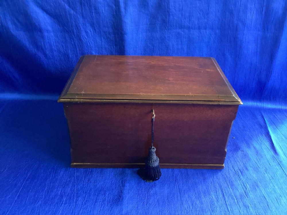 A rectangular dark mahogany storage box featuring a hinged lid with moulded edges and a central keyhole. View II