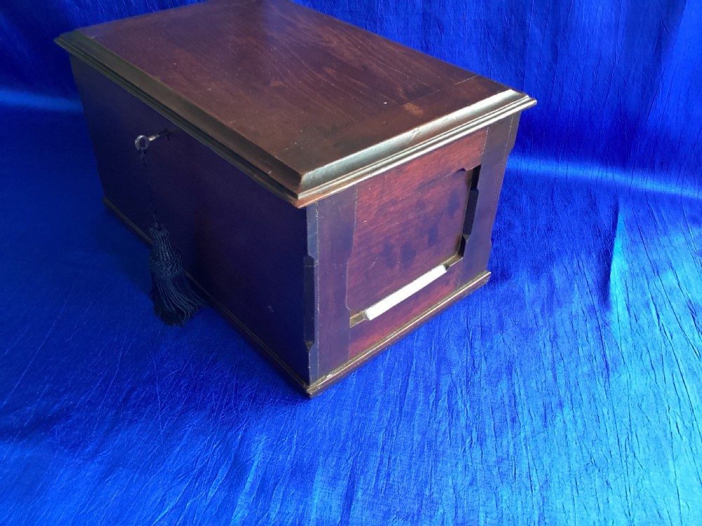 A rectangular dark mahogany storage box featuring a hinged lid with moulded edges and a central keyhole. View IV