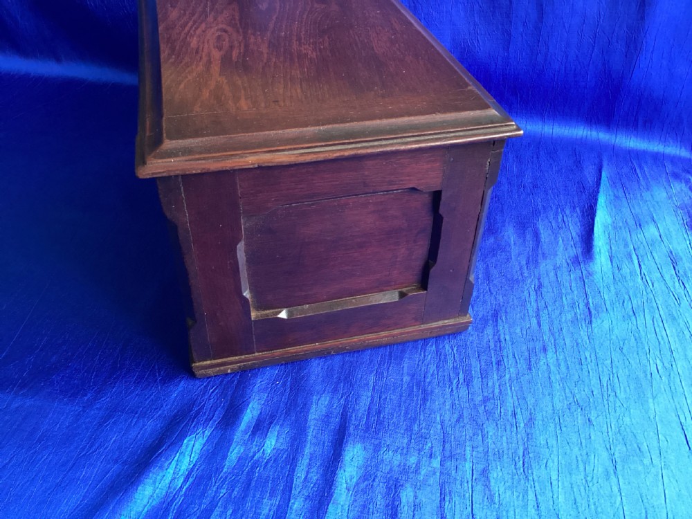 A rectangular dark mahogany storage box featuring a hinged lid with moulded edges and a central keyhole. View VII