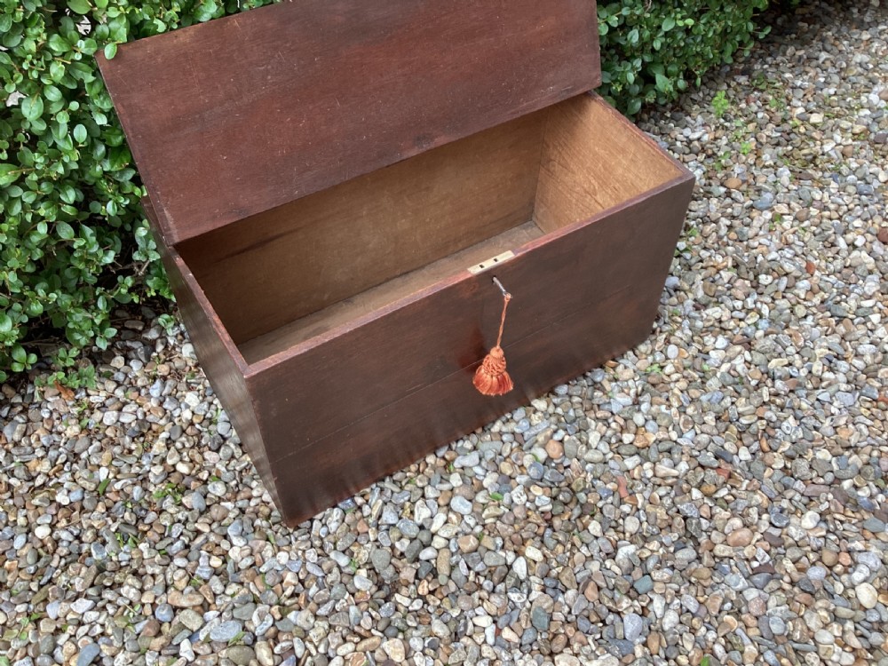 A rectangular dark mahogany wooden bible box featuring brass strap hinges on top and a keyhole with a decorative tassel on the front. View IX