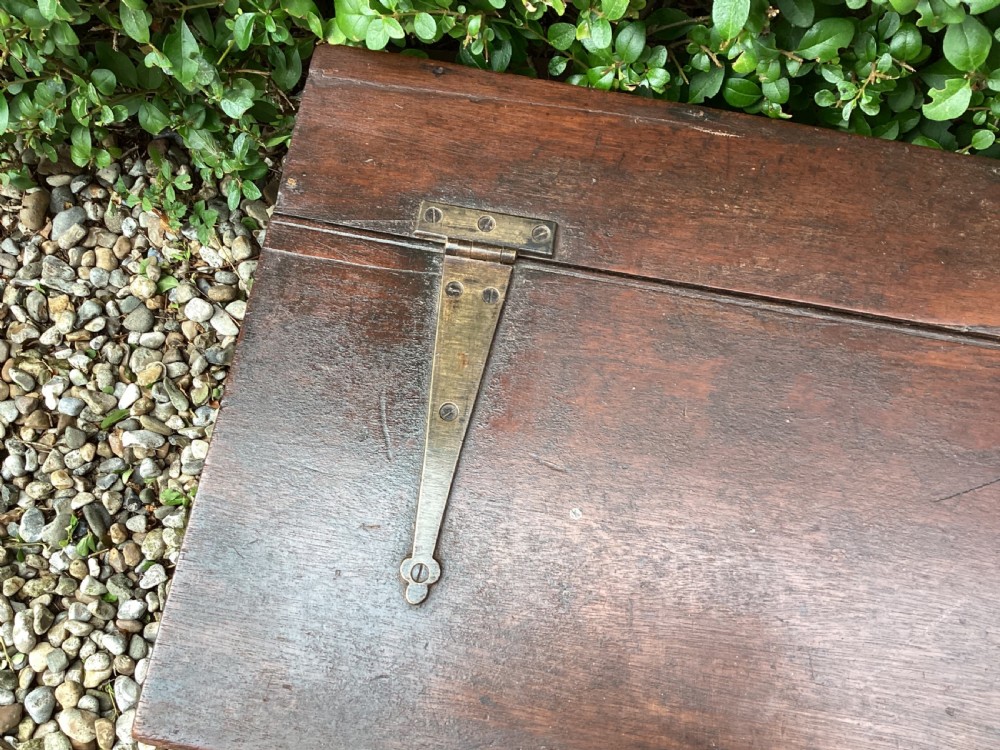 A rectangular dark mahogany wooden bible box featuring brass strap hinges on top and a keyhole with a decorative tassel on the front. View X