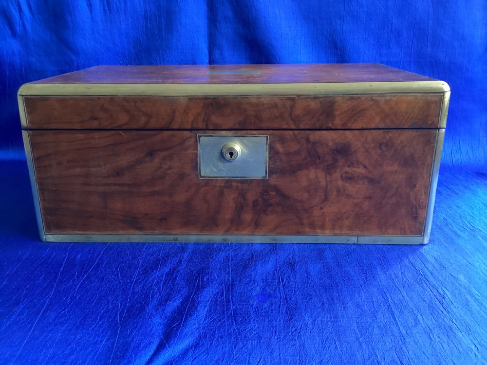 A rectangular Georgian mahogany writing slope featuring brass bound edges, flush corner fittings, and a central brass keyhole plate.