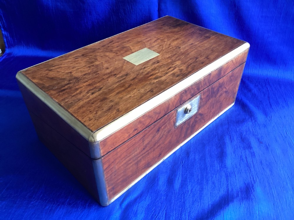 A rectangular Georgian mahogany writing slope featuring brass bound edges, flush corner fittings, and a central brass keyhole plate. View II