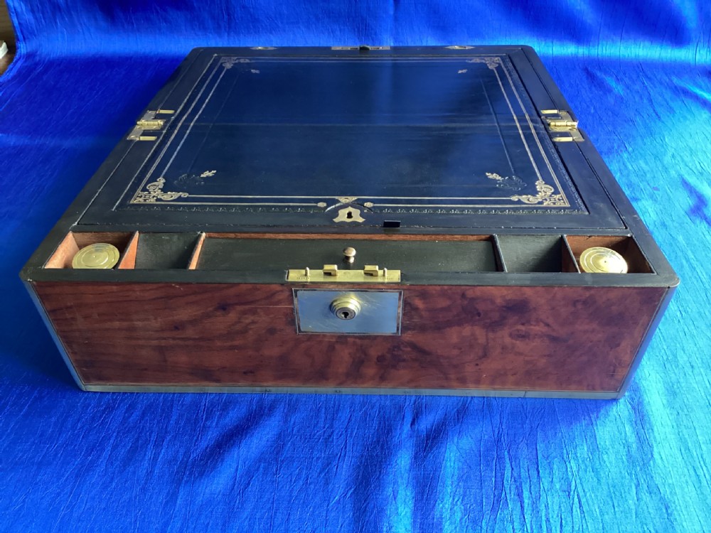A rectangular Georgian mahogany writing slope featuring brass bound edges, flush corner fittings, and a central brass keyhole plate. View V