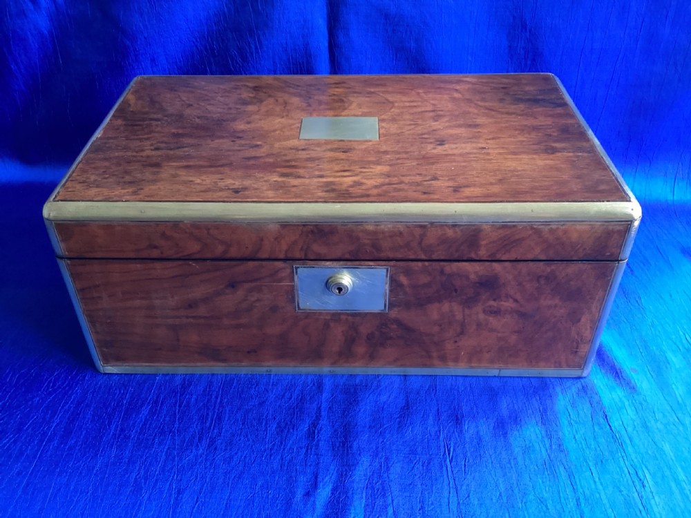 A rectangular Georgian mahogany writing slope featuring brass bound edges, flush corner fittings, and a central brass keyhole plate. View VI