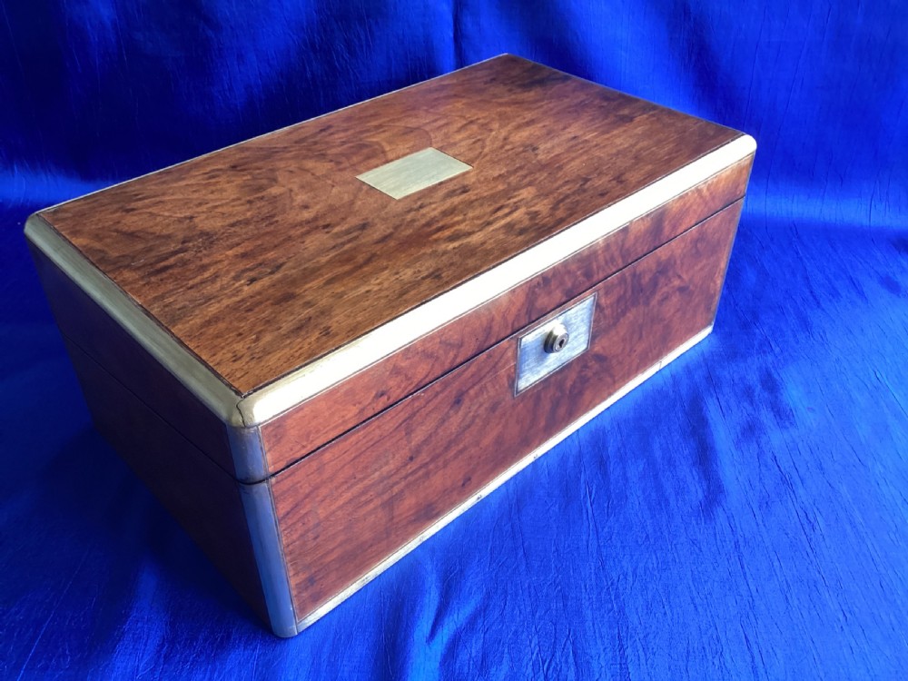 A rectangular Georgian mahogany writing slope featuring brass bound edges, flush corner fittings, and a central brass keyhole plate. View VII