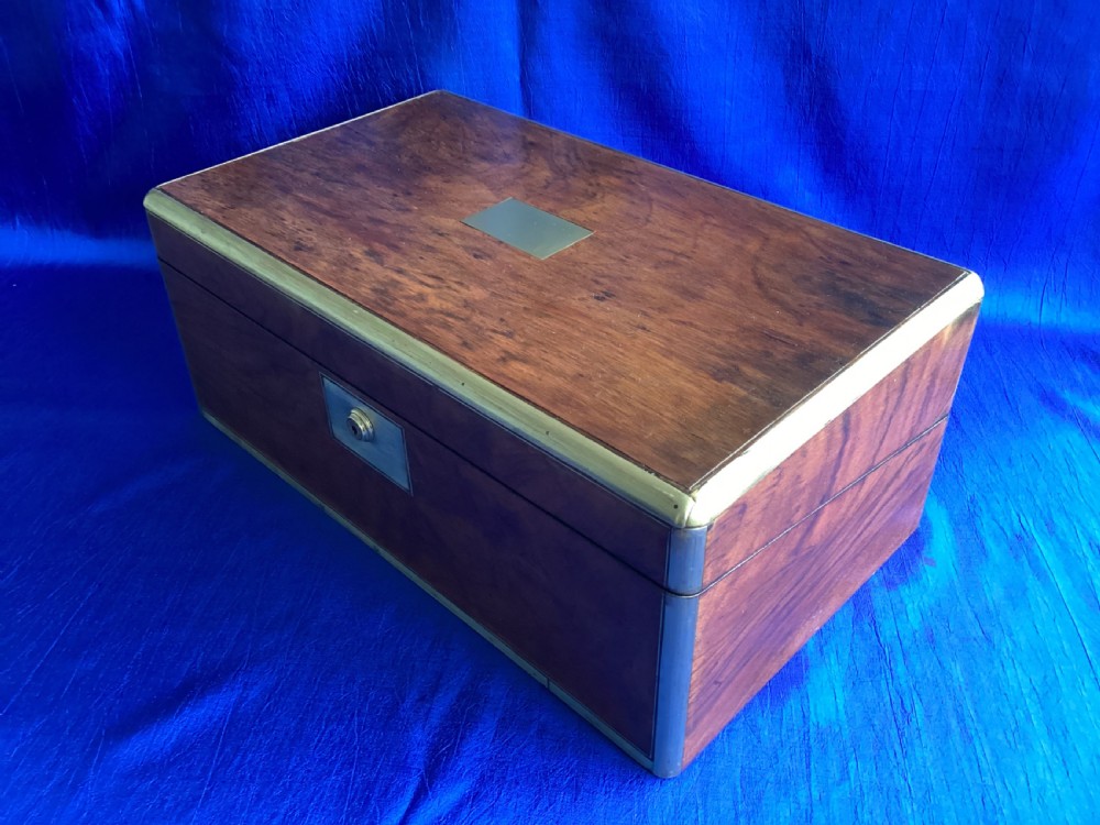 A rectangular Georgian mahogany writing slope featuring brass bound edges, flush corner fittings, and a central brass keyhole plate. View VIII