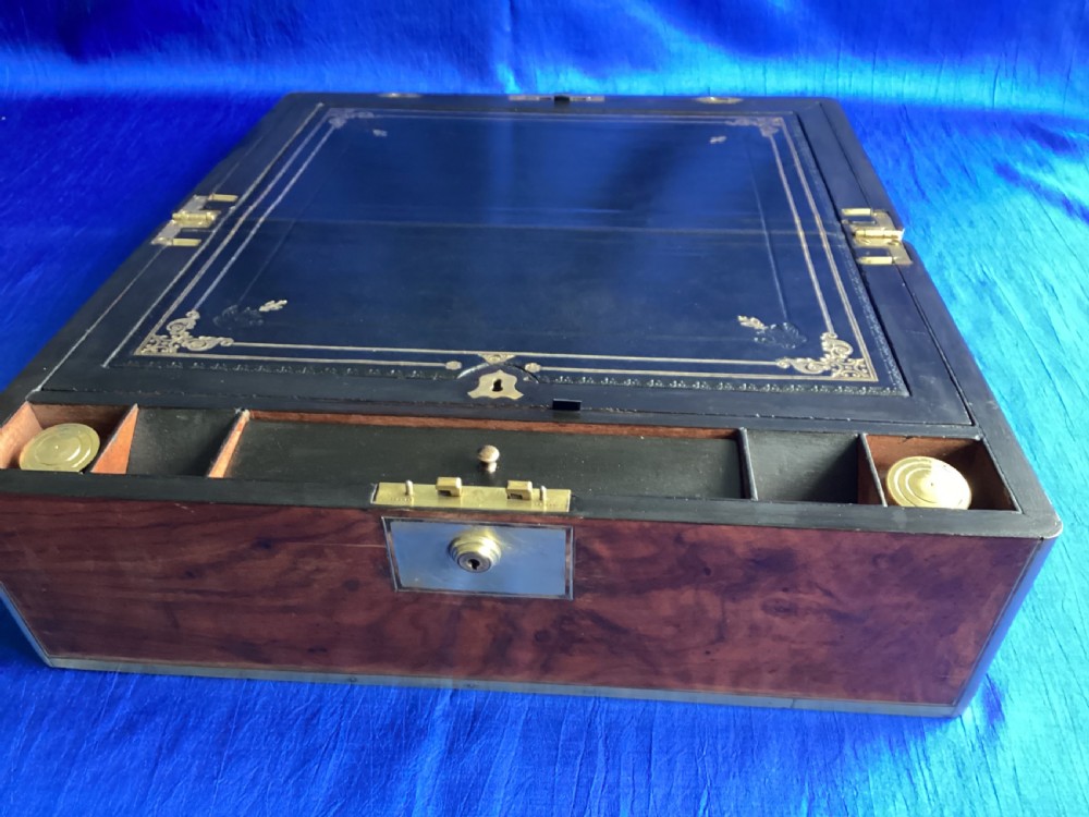 A rectangular Georgian mahogany writing slope featuring brass bound edges, flush corner fittings, and a central brass keyhole plate. View IX