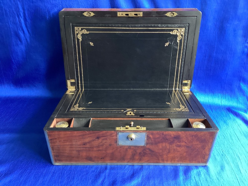 A rectangular Georgian mahogany writing slope featuring brass bound edges, flush corner fittings, and a central brass keyhole plate. View X