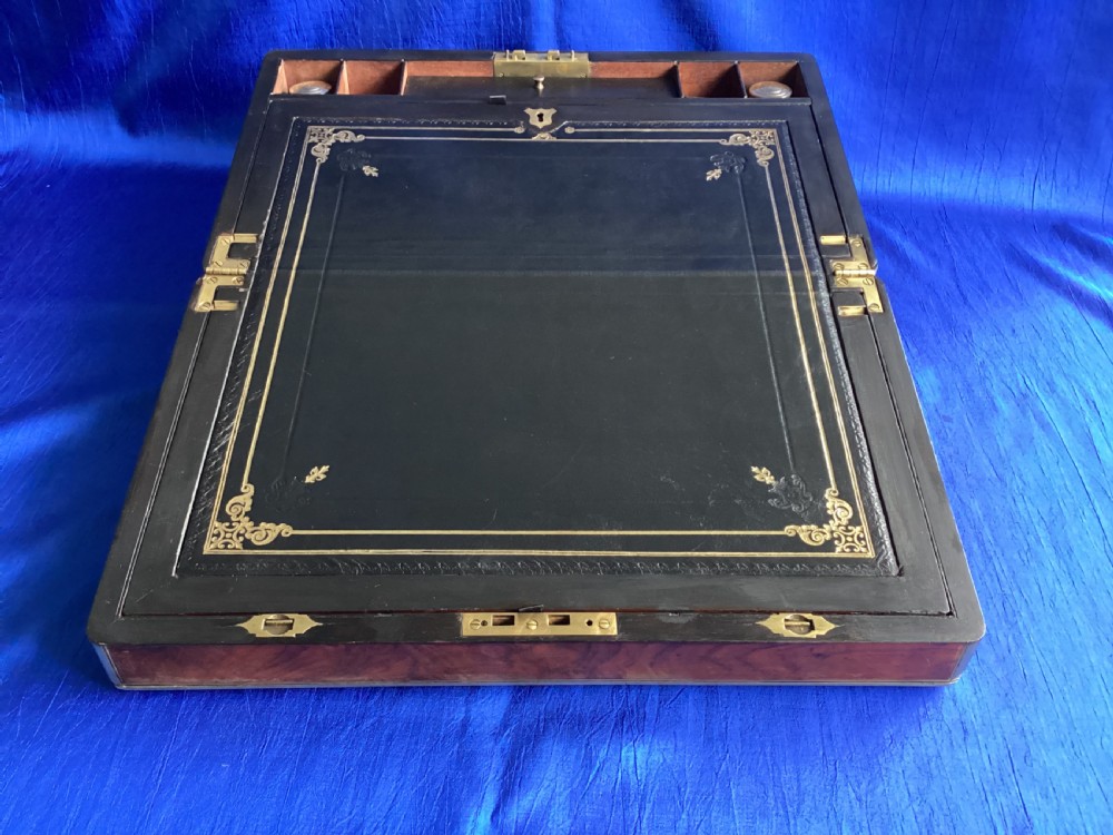 A rectangular Georgian mahogany writing slope featuring brass bound edges, flush corner fittings, and a central brass keyhole plate. View XI