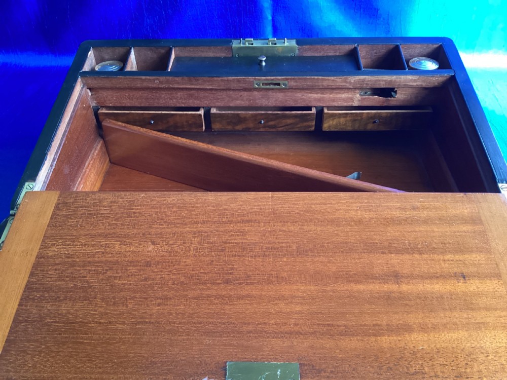A rectangular Georgian mahogany writing slope featuring brass bound edges, flush corner fittings, and a central brass keyhole plate. View XII