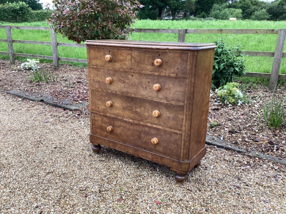 A Victorian pine chest of drawers featuring two short upper drawers over three long lower drawers, fitted with round turned wooden handles and short turned legs. View III