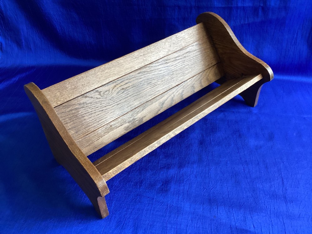 An Edwardian medium brown oak book slide featuring shaped end supports and an adjustable sliding base board. View IV
