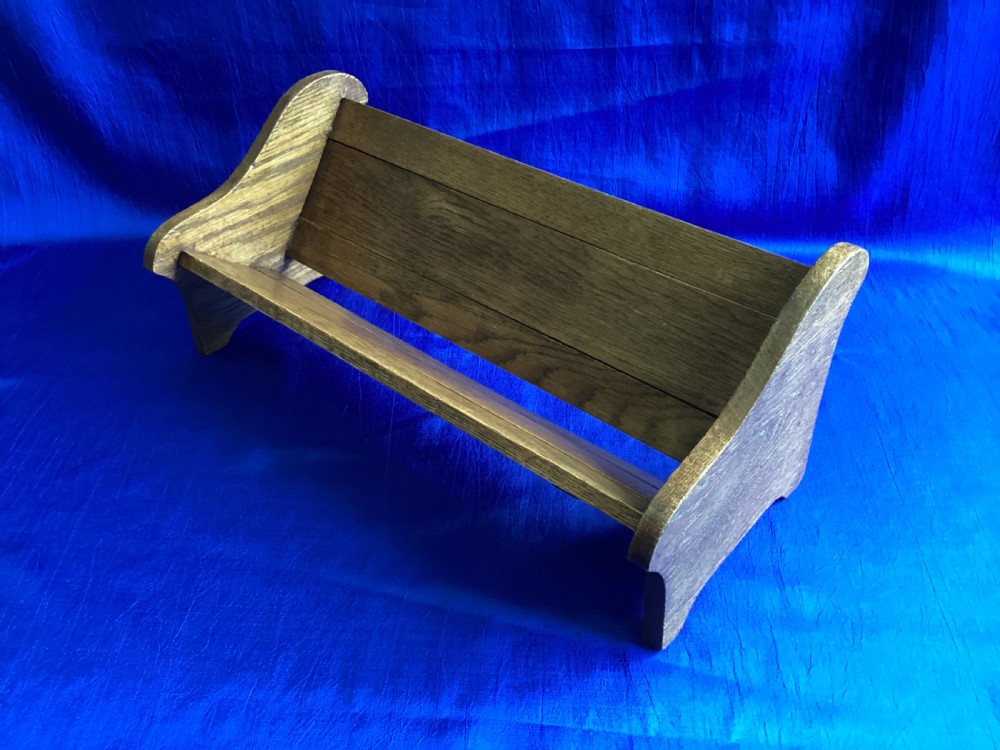 An Edwardian medium brown oak book slide featuring shaped end supports and an adjustable sliding base board. View VI