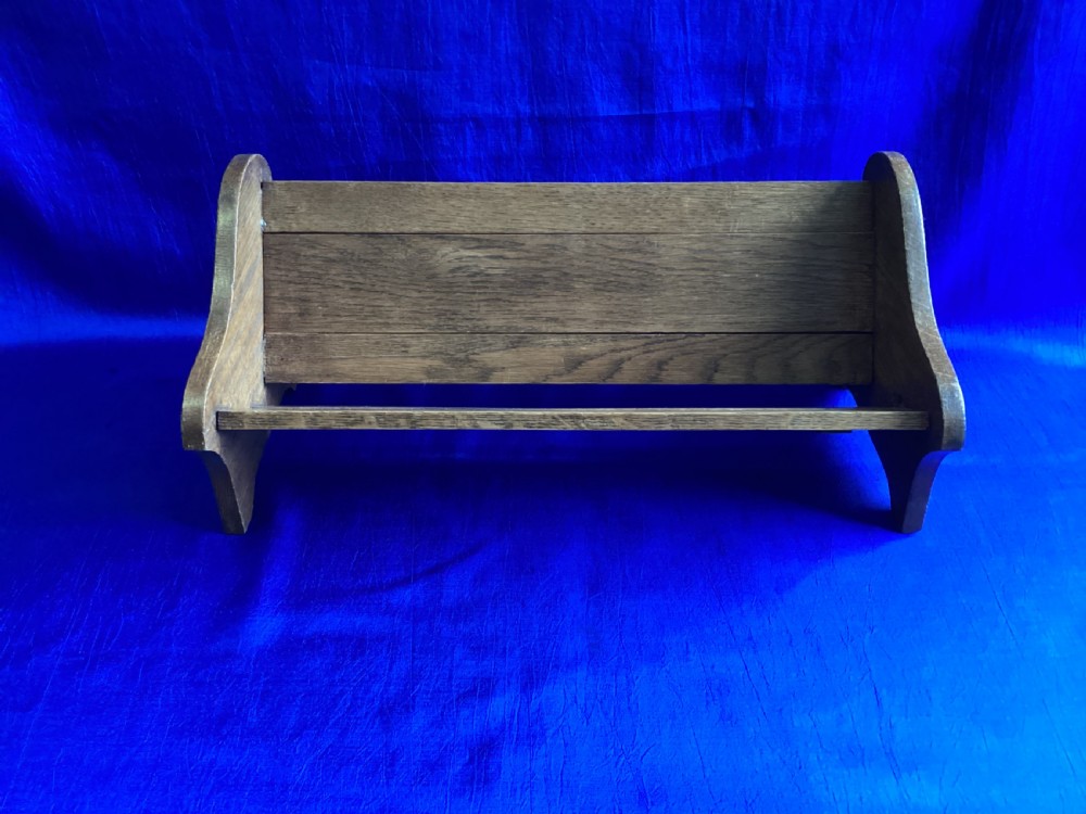 An Edwardian medium brown oak book slide featuring shaped end supports and an adjustable sliding base board. View VII