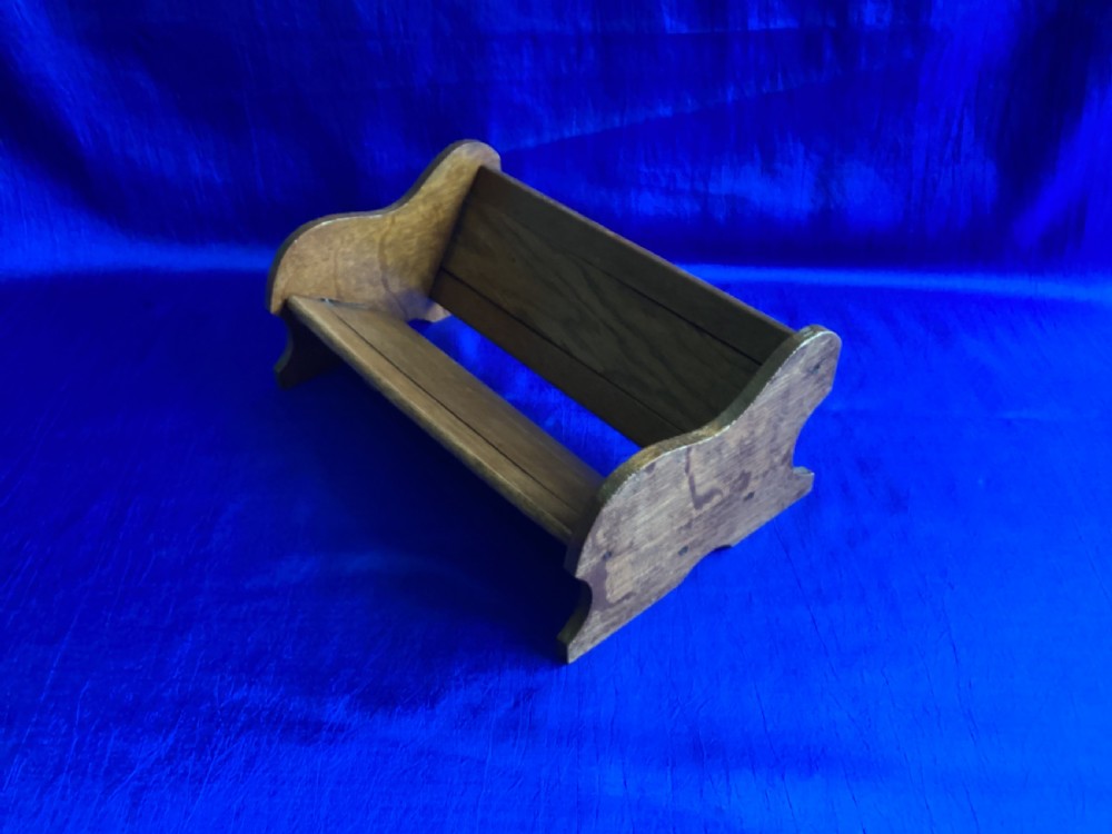 An antique oak extending book slide with shaped side panels on a blue background. View IV