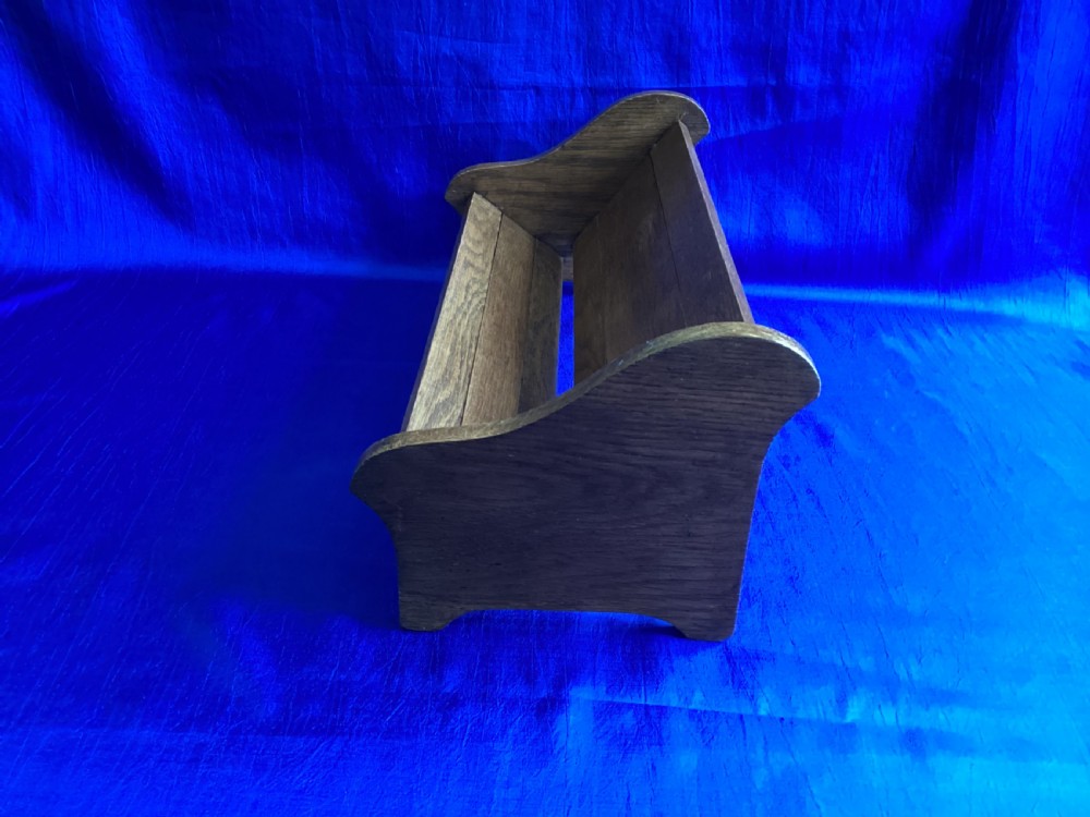 An antique oak extending book slide with shaped side panels on a blue background. View VI