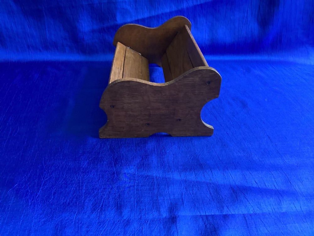 An antique oak extending book slide with shaped side panels on a blue background. View VII