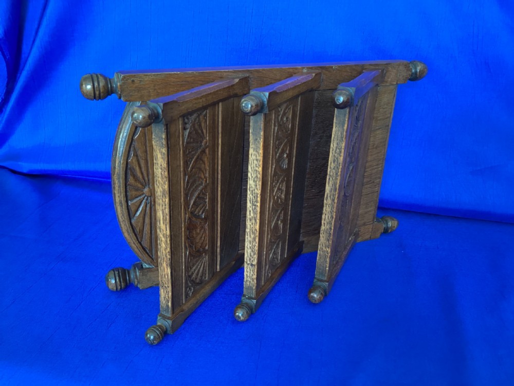 A carved oak desk letter rack featuring three tiered compartments, turned corner finials, and arched decorative carving. View II
