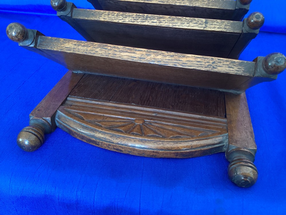 A carved oak desk letter rack featuring three tiered compartments, turned corner finials, and arched decorative carving. View III