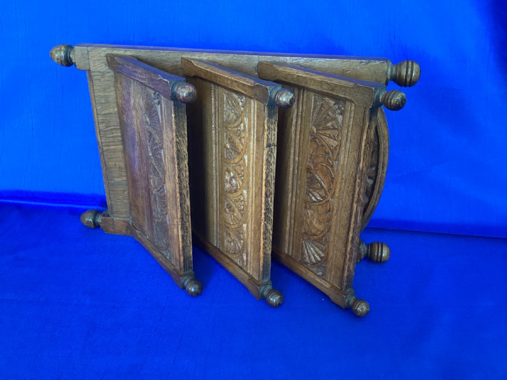 A carved oak desk letter rack featuring three tiered compartments, turned corner finials, and arched decorative carving. View IV