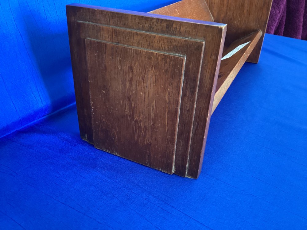 A dark mahogany wooden book trough featuring angled shelf boards and rectangular side supports. View III