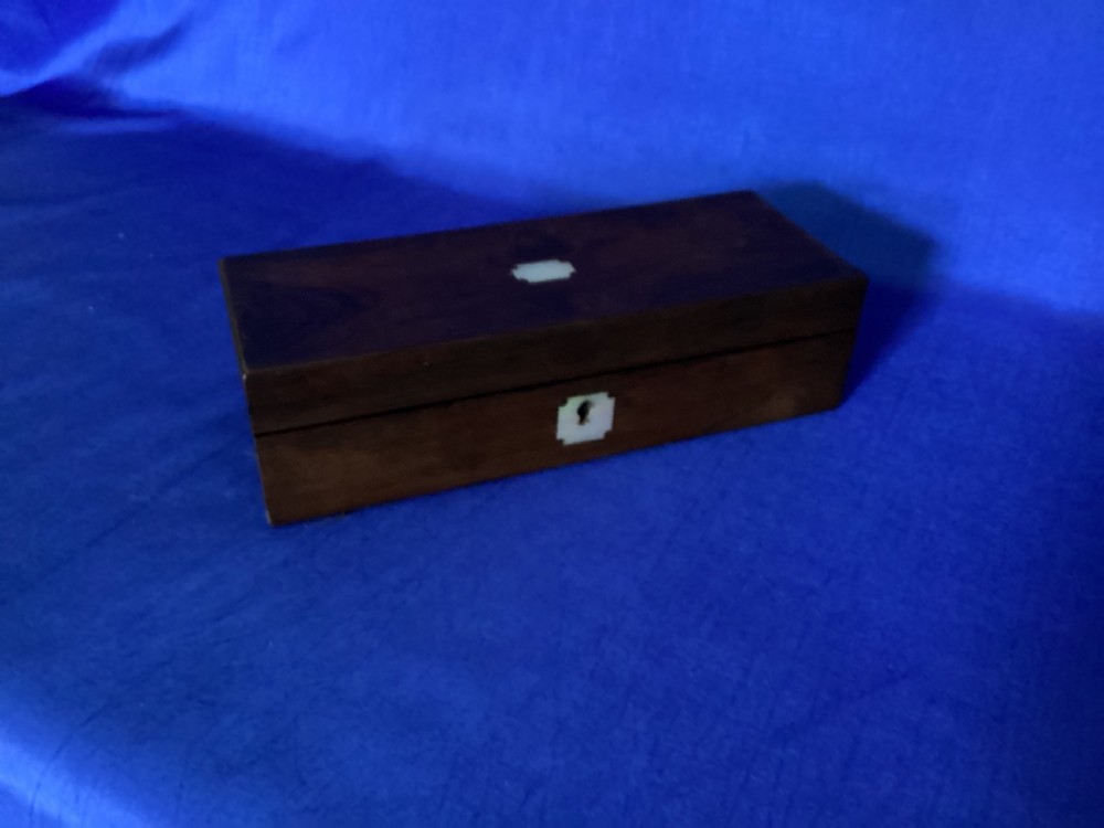 A rectangular Victorian dark rosewood glove box with a mother-of-pearl cartouche inlay on the lid and a matching keyhole escutcheon on the front. View IV