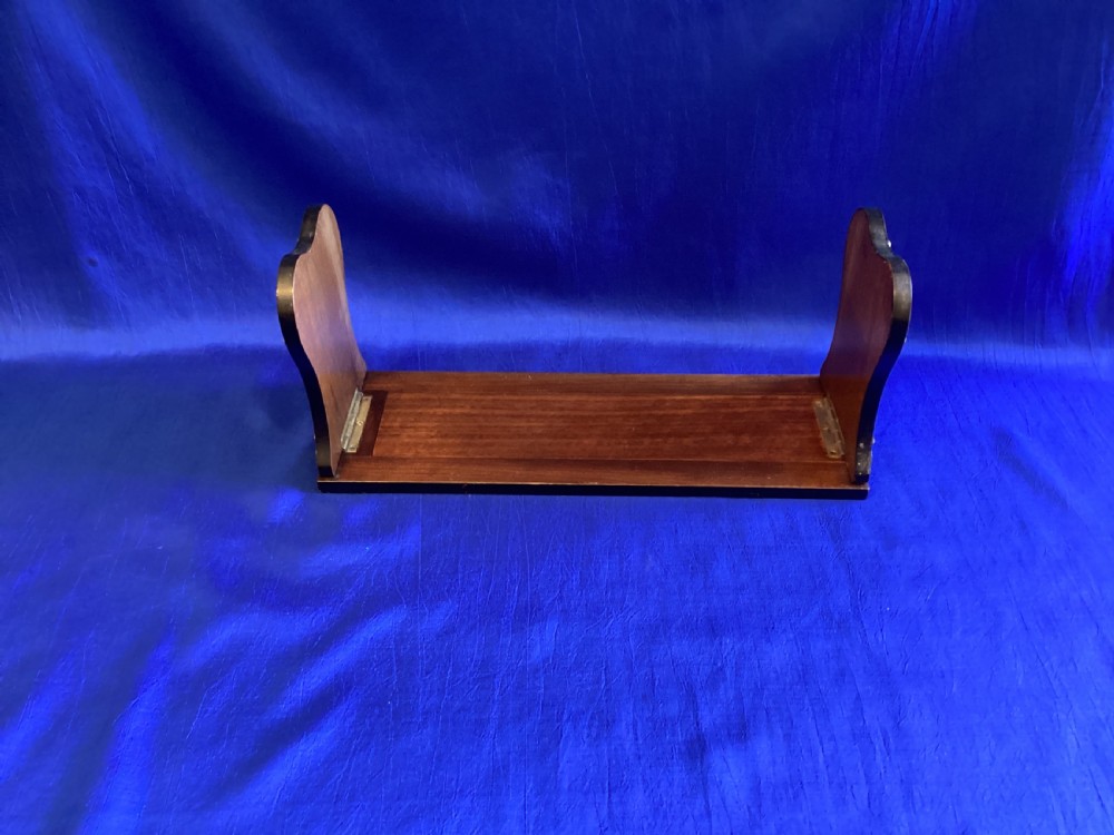 A dark mahogany extending book rest featuring decorative pierced brass scrollwork end panels with stud embellishments. View IV