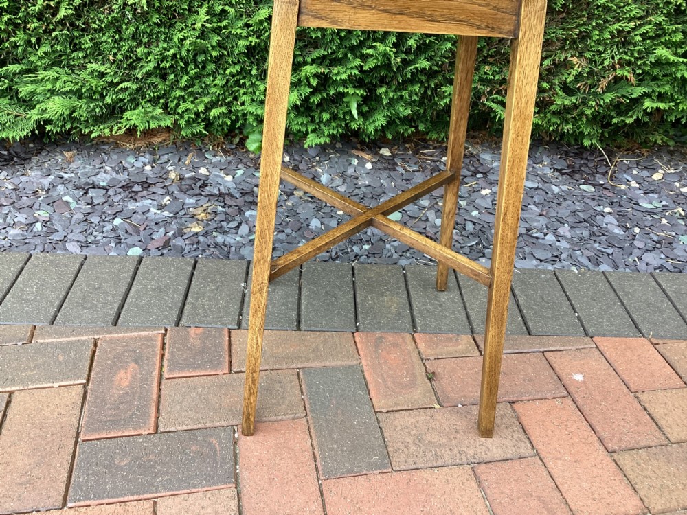 A rectangular solid oak Arts and Crafts side table featuring splayed tapered legs and an X-frame lower stretcher. View III