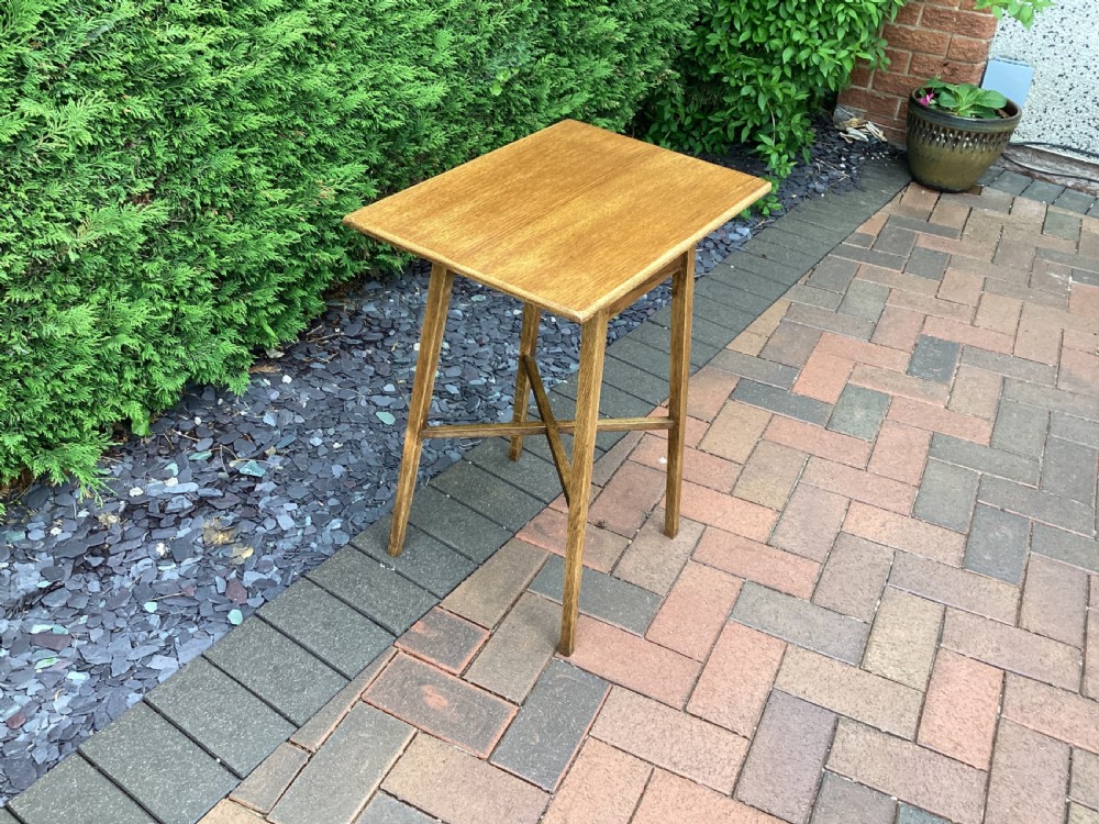 A rectangular solid oak Arts and Crafts side table featuring splayed tapered legs and an X-frame lower stretcher. View VII