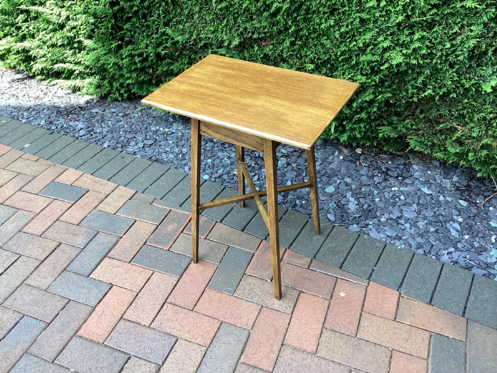 A rectangular solid oak Arts and Crafts side table featuring splayed tapered legs and an X-frame lower stretcher. View VIII