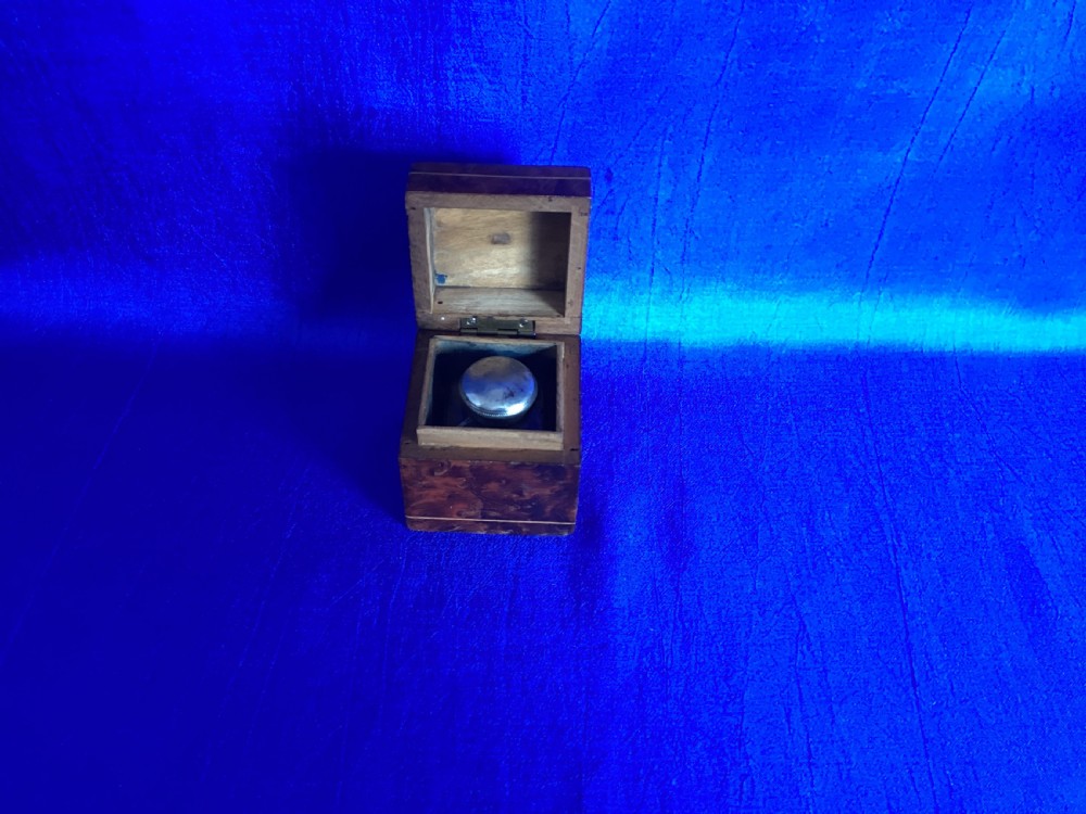 A small square Victorian burr walnut travelling inkwell box featuring detailed mosaic wood inlay on the lid. View V