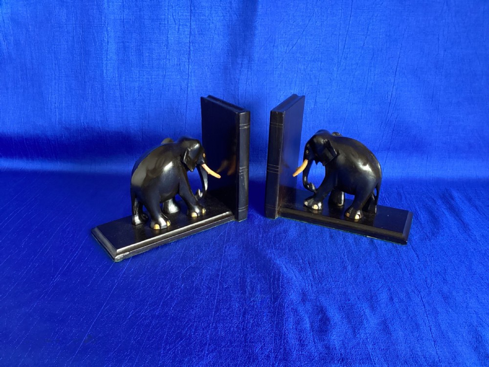 A pair of carved black ebony bookends shaped as elephants with bone tusks and toes. View III
