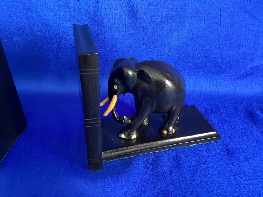 A pair of carved black ebony bookends shaped as elephants with bone tusks and toes. View IV