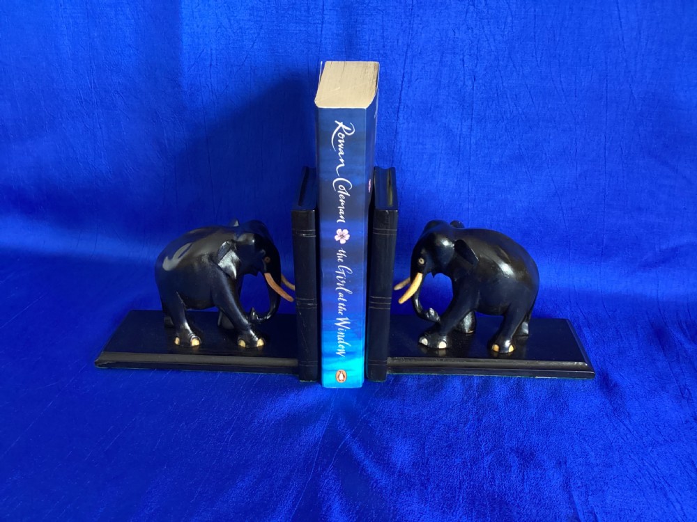A pair of carved black ebony bookends shaped as elephants with bone tusks and toes. View V