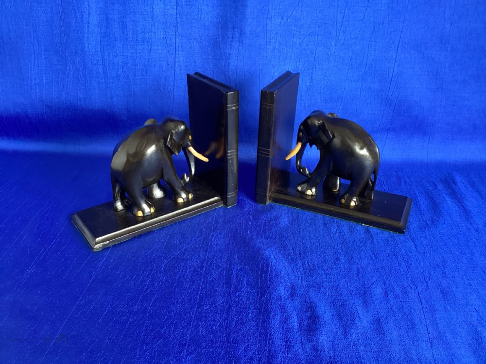A pair of carved black ebony bookends shaped as elephants with bone tusks and toes. View VI