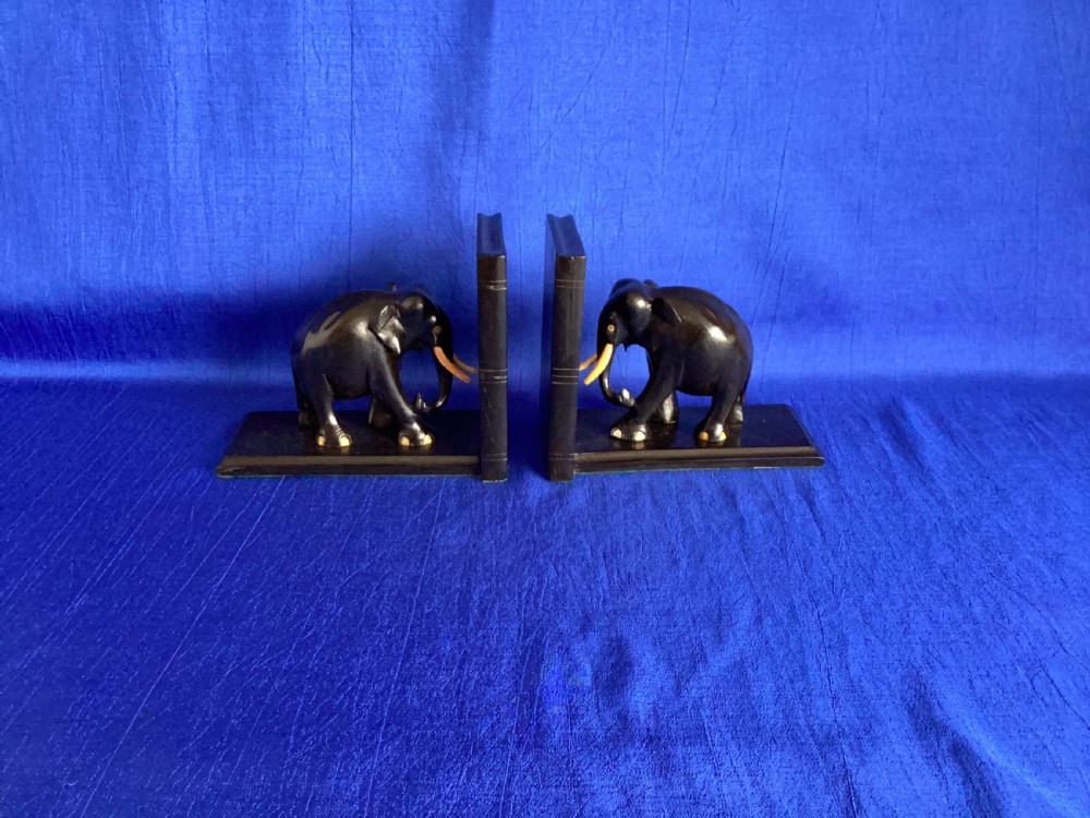 A pair of carved black ebony bookends shaped as elephants with bone tusks and toes. View VIII