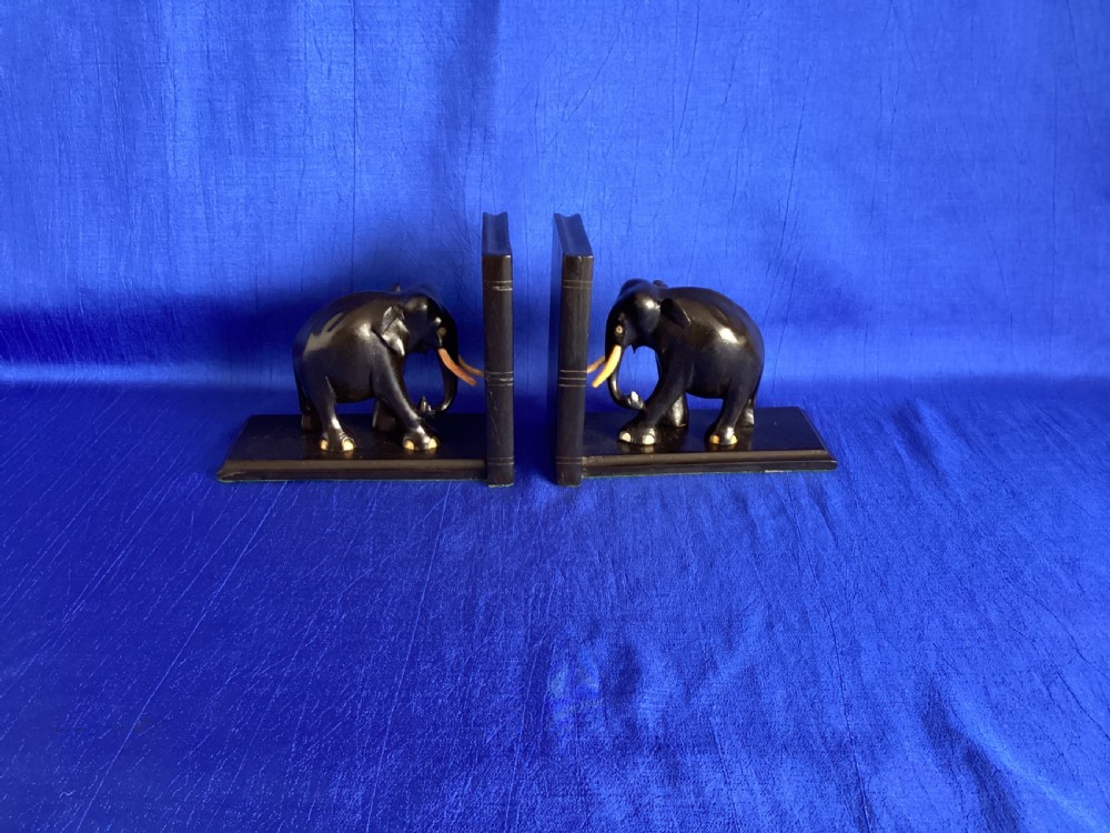 A pair of carved black ebony bookends shaped as elephants with bone tusks and toes. View IX